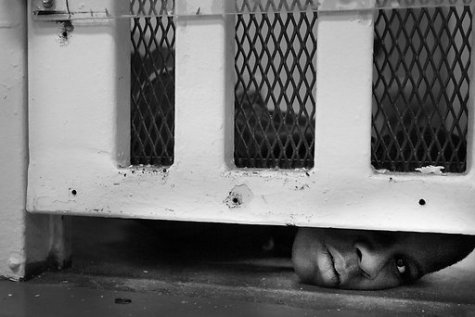 60% of children under the Texas juvenile prison system come from low-income homes. Texas spends more than twice as much per prisoner as per pupil. Laying on the floor, thirteen-year-old Drake Swist peers out from underneath the bars on his cell door in the security unit of the Marlin facility. Kids get their first glimpse of life in the Texas Youth Commission through the Orientation and Assessment facility in Marlin, Texas. 